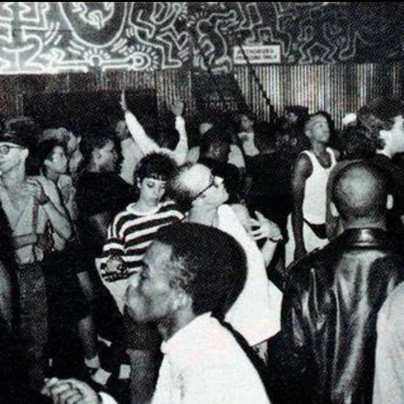 Black-and-white photo of a crowded dance floor in a New York club