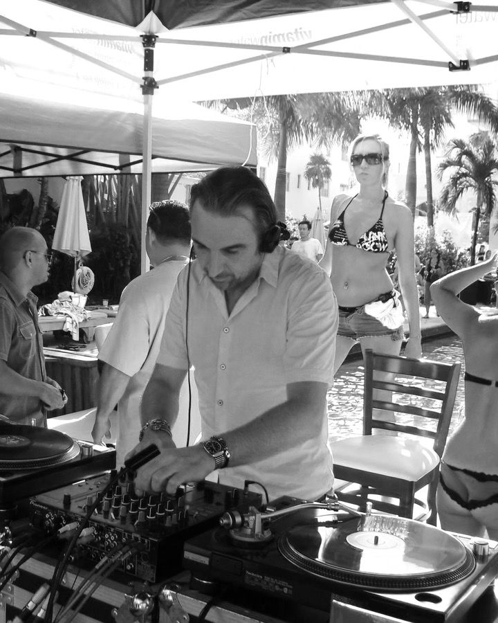 Gene Douglas DJing at a pool party